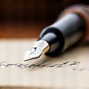 A fountain pen writing in a journal.
