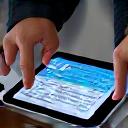 Two people collaborating over a tablet.